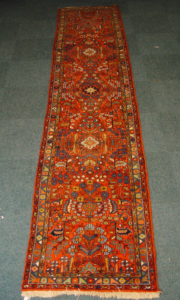 Appraisal: Rectangular carpet runner decorated with multi coloured flowers onto a