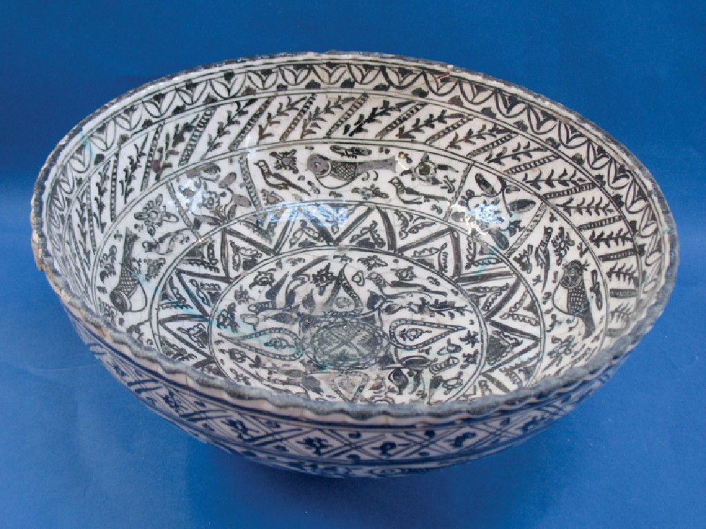 Appraisal: A PERSIAN POTTERY BOWL decorated with birds stylised flowers and