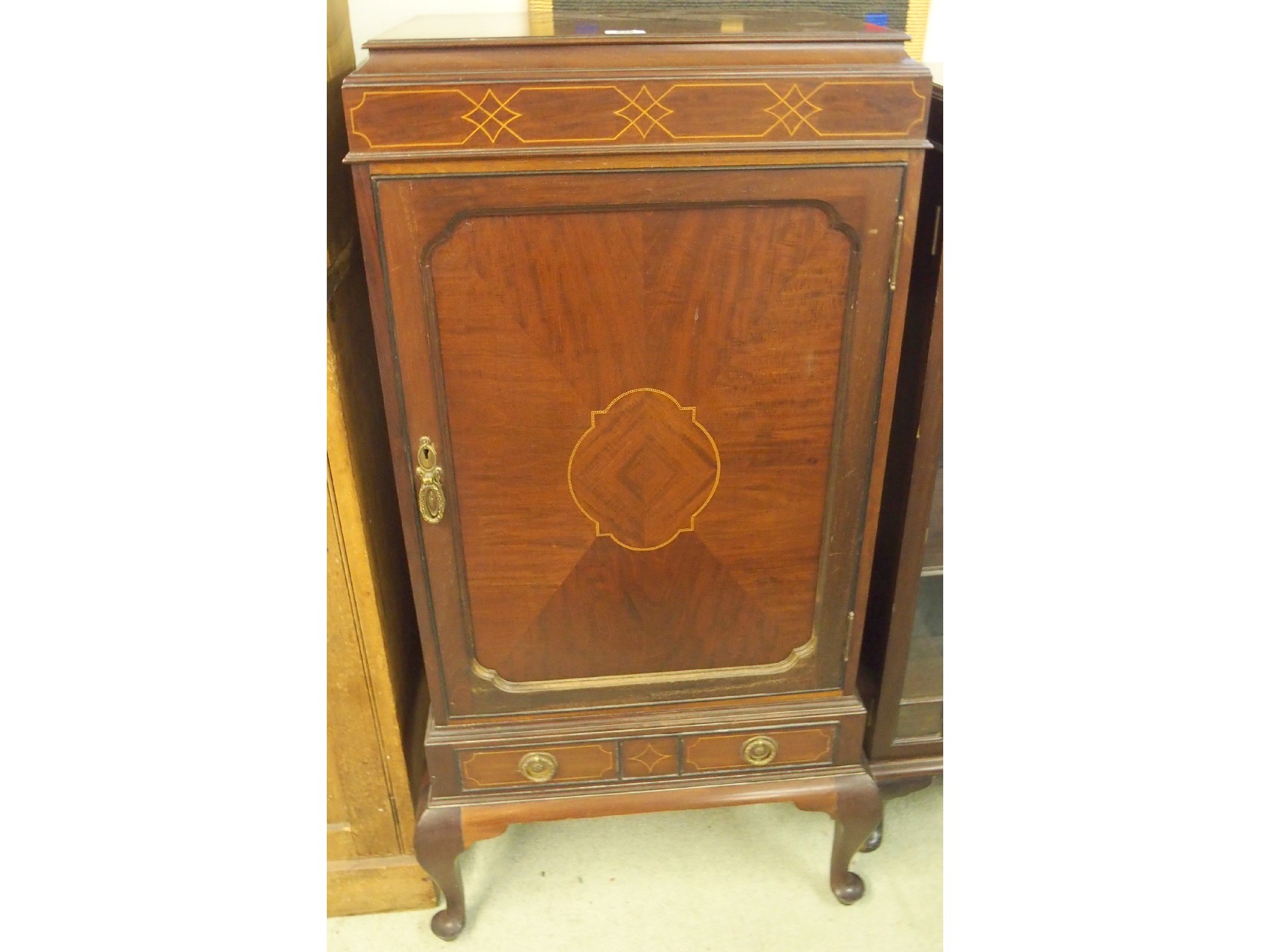 Appraisal: An inlaid mahogany music cabinet