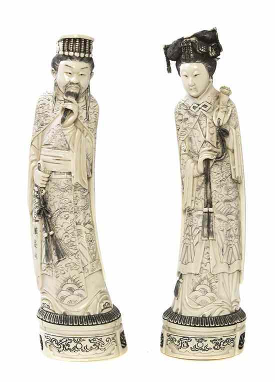 Appraisal: A Pair of Carved Ivory Figures the woman shown with