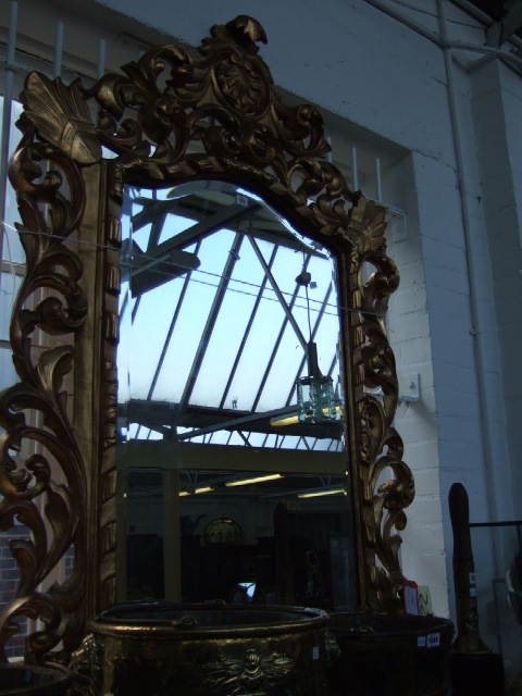 Appraisal: A th century carved gilt framed wall mirror the shell