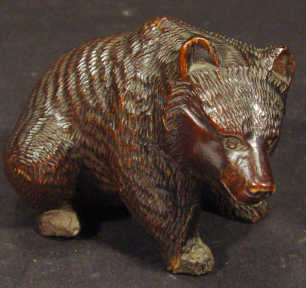 Appraisal: Black Forest carved wooden seated bear cm high