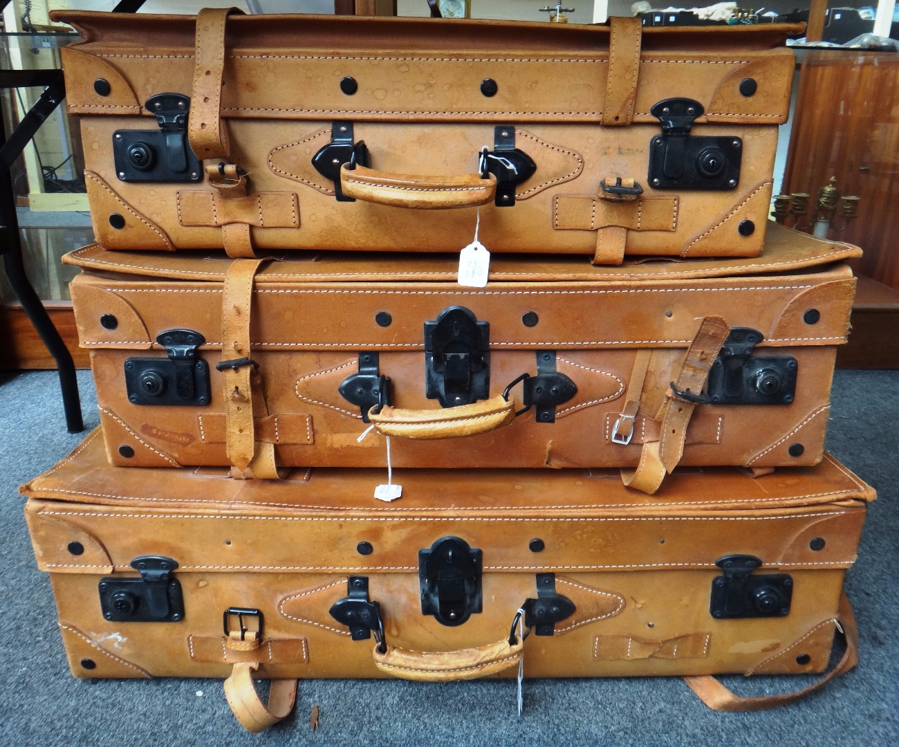 Appraisal: A graduated set of three faux leather suitcases the largest