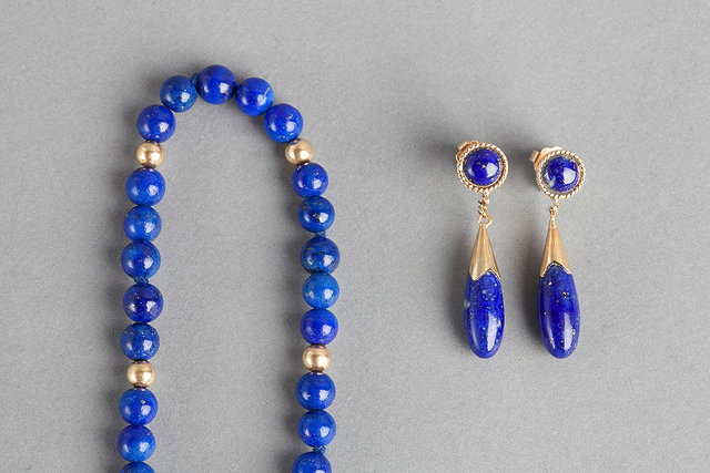 Appraisal: A LAPIS LAZULI BEAD NECKLACE with gold spacers clasp stamped