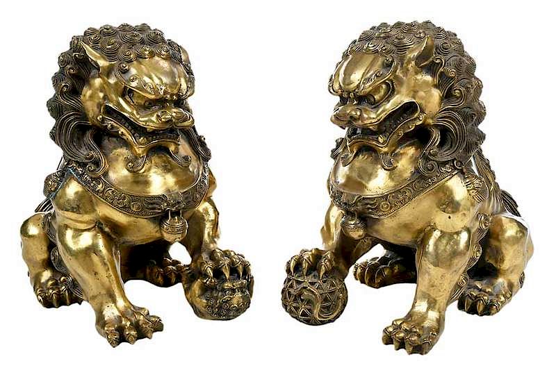 Appraisal: Pair Gilt Bronze Foo Lions Chinese th century ferocious looking