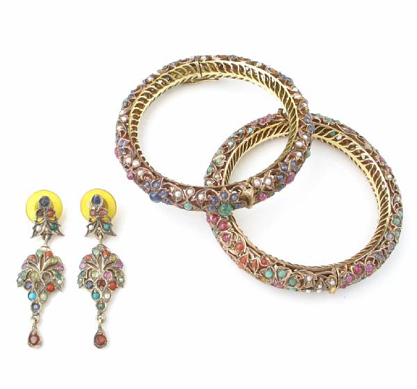 Appraisal: A pair of gem-set and nine karat gold bangles and