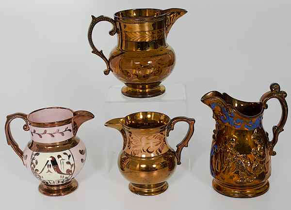 Appraisal: English Copper Luster Pitchers England A group four handled copper