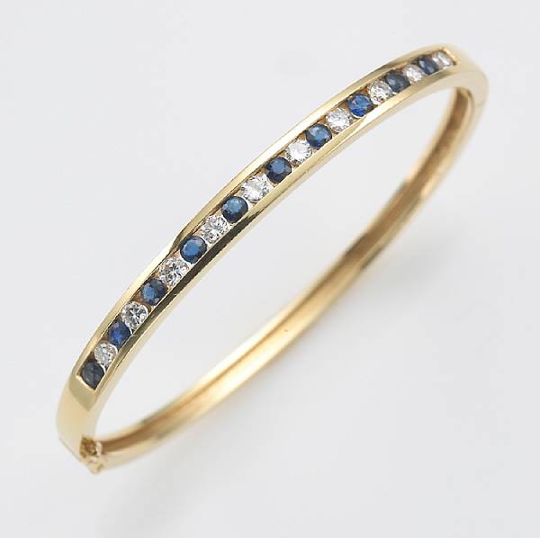 Appraisal: A sapphire diamond and eighteen karat gold bangle bracelet size