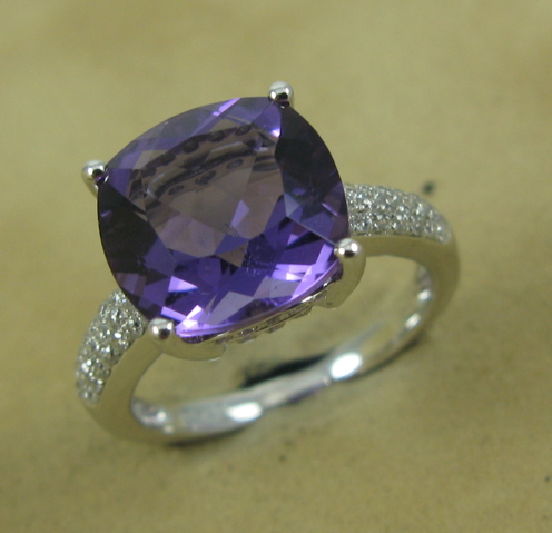 Appraisal: AMETHYST DIAMOND AND FOURTEEN KARAT GOLD RING centering a cushion