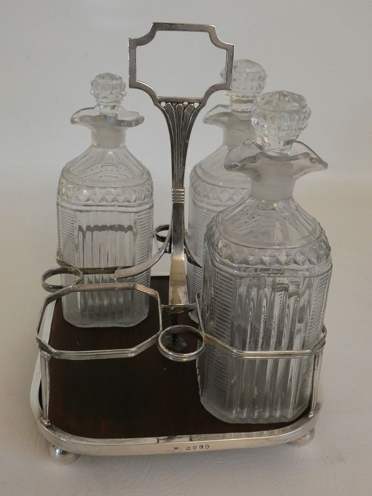 Appraisal: GEORGIAN SILVER DECANTER SET Early Georgian bottle decanter set original