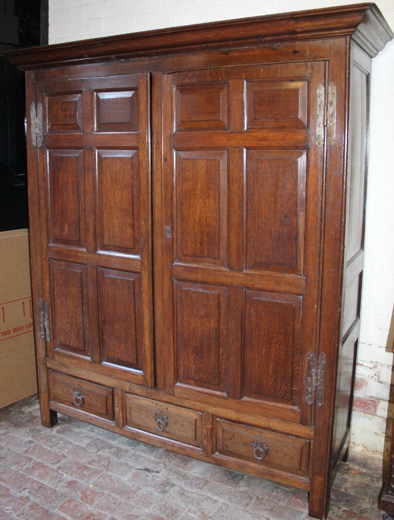 Appraisal: An thC oak hall cupboard wardrobe with overhanging cornice raised