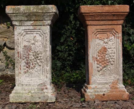 Appraisal: A PAIR OF WHITE PAINTED TERRACOTTA PLINTHS with cast grapevine