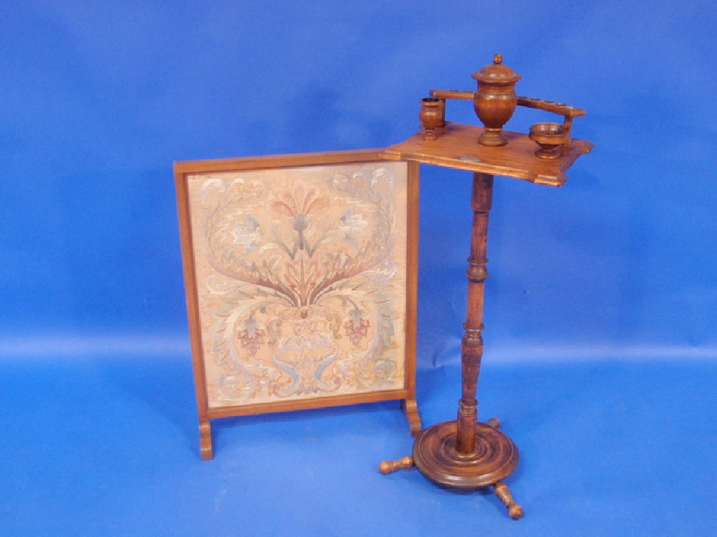 Appraisal: A turned beech pipe stand and a fire screen