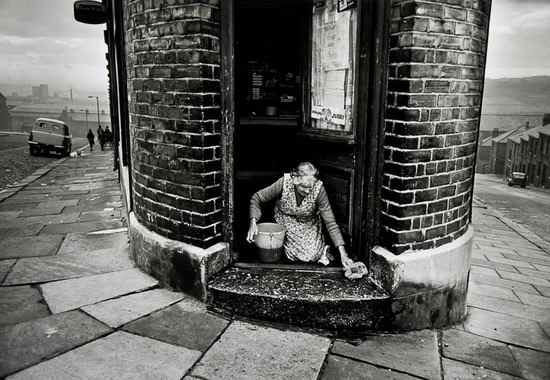 Appraisal: Colin Jones b A Shopkeeper Washing her Doorstep Benwell Newcastle