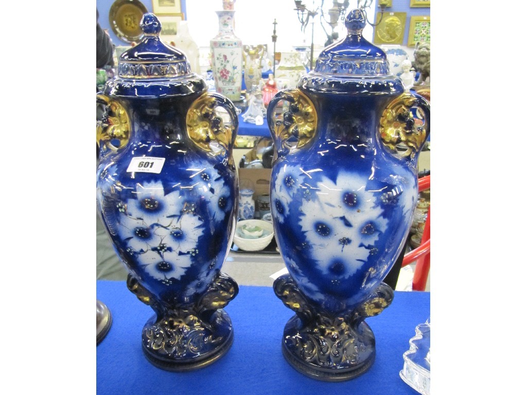 Appraisal: Pair of pottery urns and covers with floral decoration in