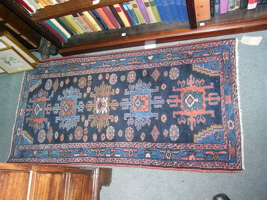 Appraisal: A SMALL BLUE GROUND ORIENTAL RUG with foliate motifs and