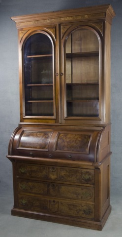 Appraisal: American Walnut Roll-Top Desk Bookcase th century Two-piece construction The