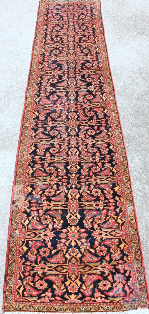 Appraisal: A Tabriz runner in red blue and cream cm x