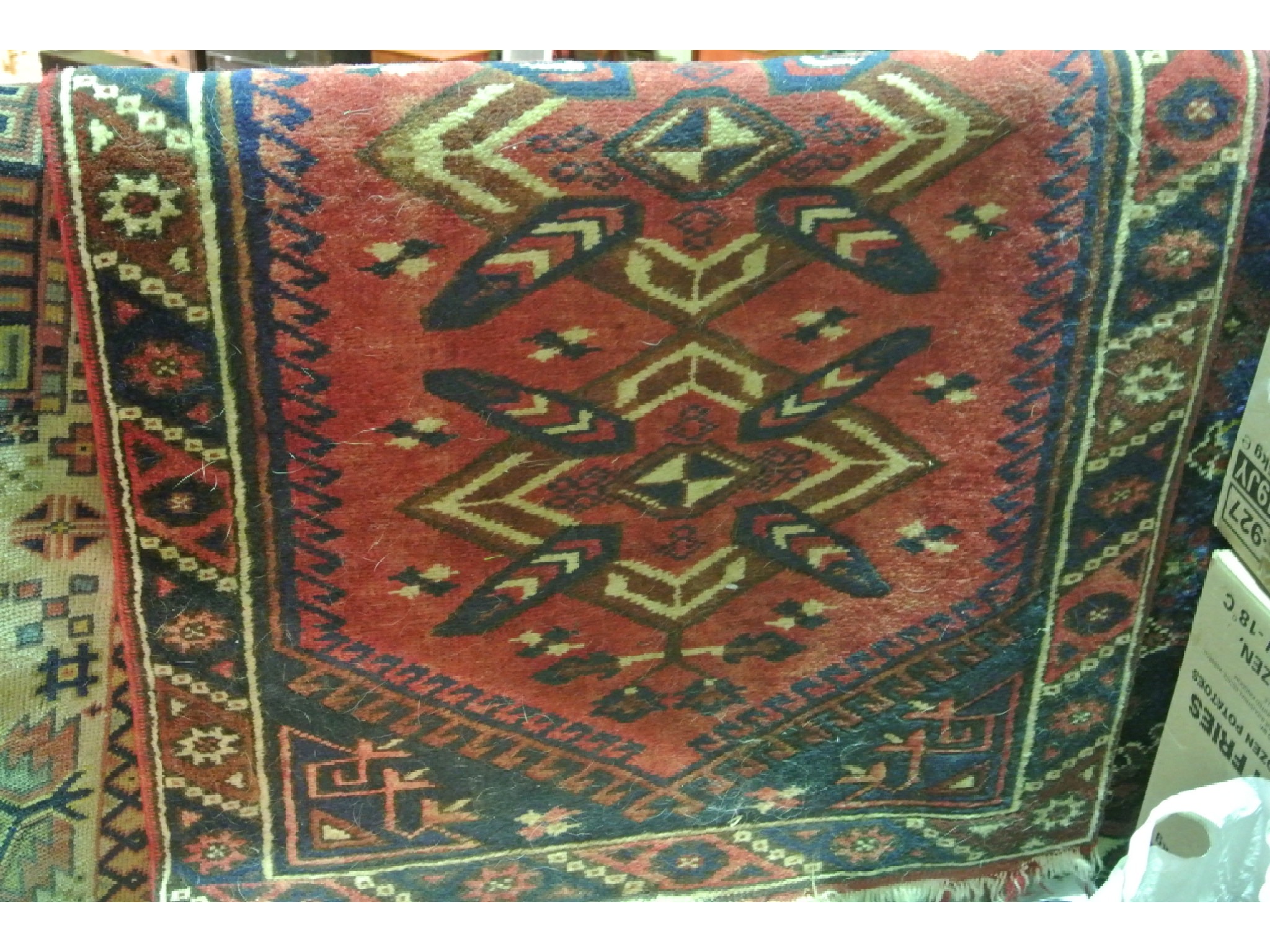 Appraisal: A small eastern woven wool rug with pink coloured ground