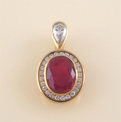 Appraisal: A synthetic ruby and diamond gold mounted oval pendant by