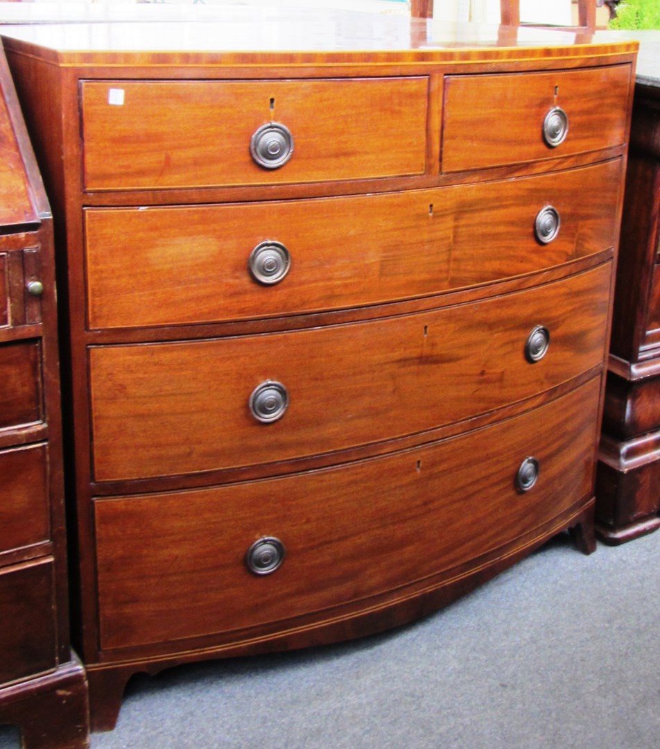 Appraisal: An early th century inlaid mahogany bowfront chest of two