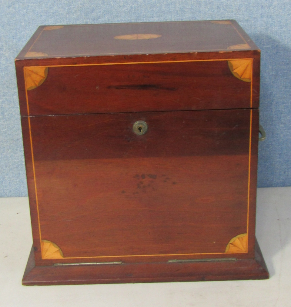 Appraisal: An Edwardian mahogany and inlaid tantalus box the mirrored lid