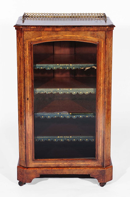 Appraisal: A Victorian walnut and inlaid music cabinetwith original leather and