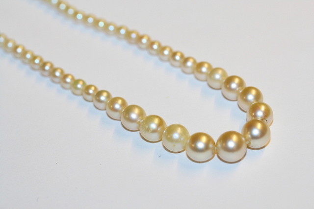 Appraisal: A CASED GRADUATED CULTURED PEARL NECKLACE with silver and marcasite