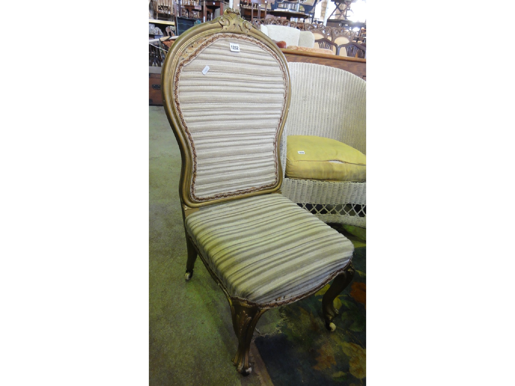 Appraisal: A Victorian nursing chair with upholstered seat and padded shield