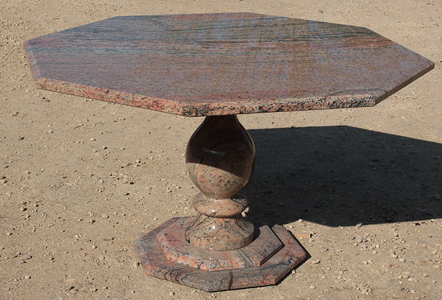 Appraisal: A LARGE OCTAGONAL PINK GRANITE TABLE standing on a central