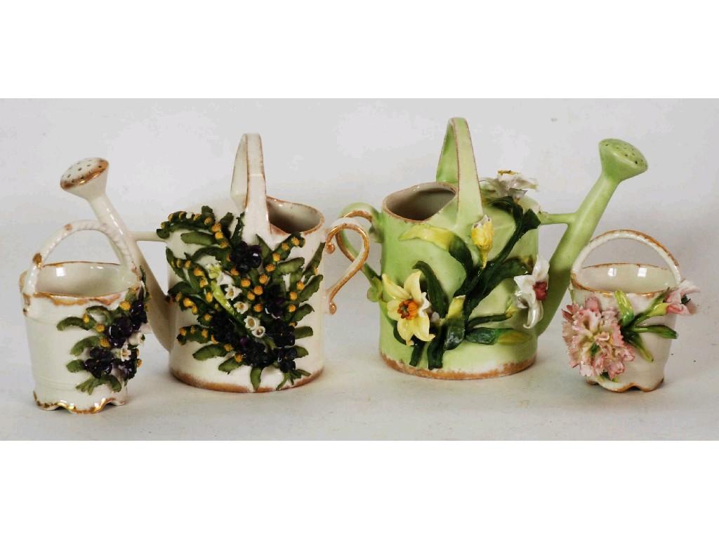 Appraisal: TWO EARLY 'S GERMAN PORCELAIN FLOWER ENCRUSTED WATERING CANS together