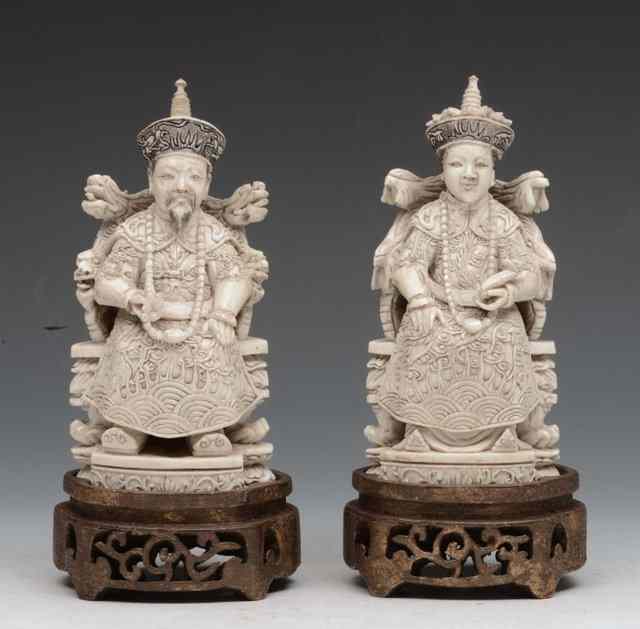 Appraisal: A PAIR OF CHINESE CARVED IVORY MODELS OF AN EMPEROR