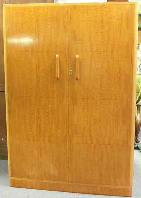 Appraisal: A satin birch wardrobe with matched veneer door