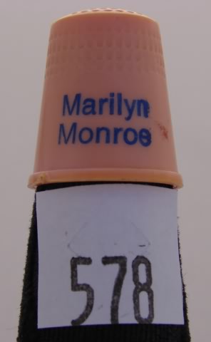 Appraisal: Orange plastic advertising thimble Marilyn Monroe