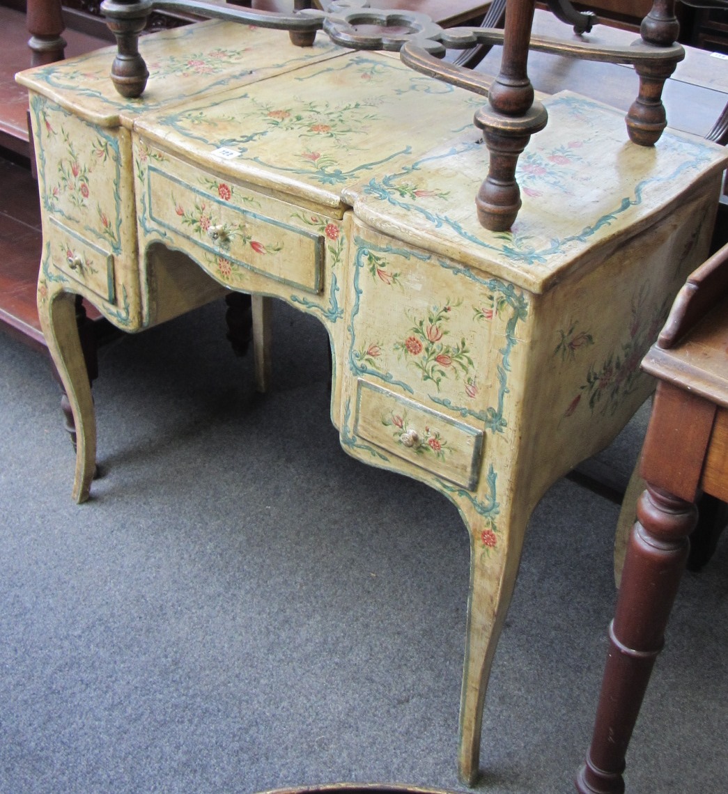 Appraisal: A Louis XV style cream and floral painted lift top