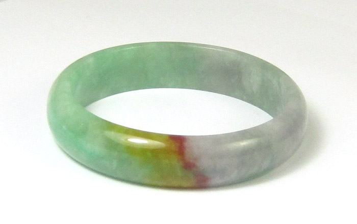 Appraisal: GREEN YELLOW AND ORANGE JADE BANGLE weighing grams and measuring