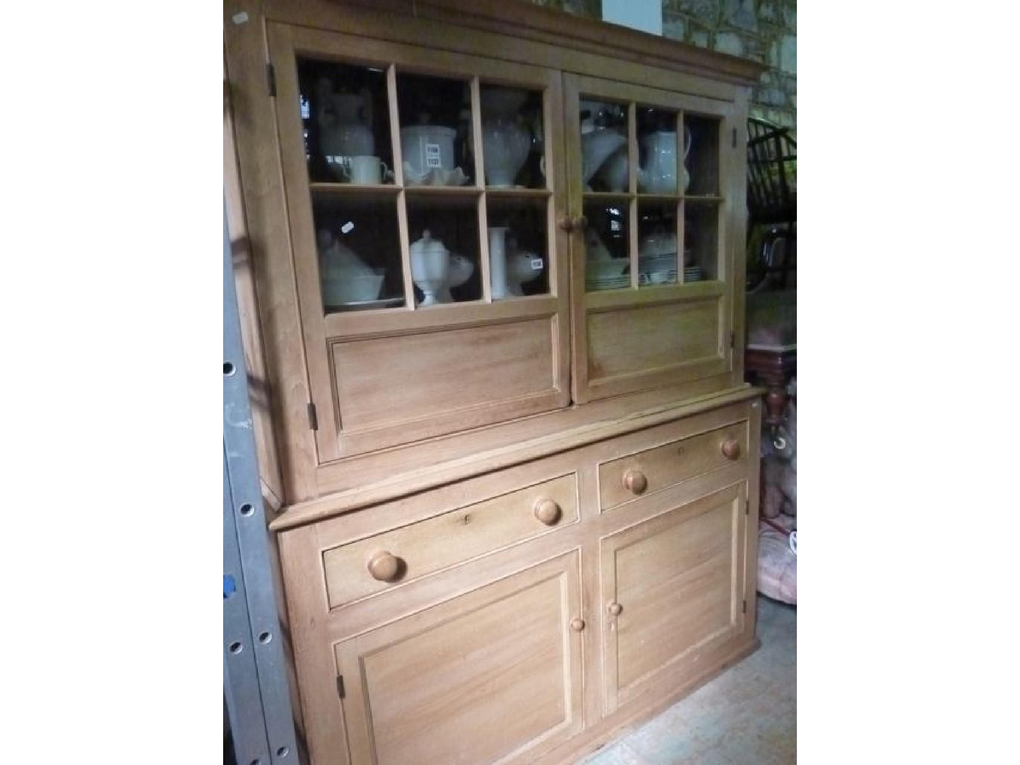 Appraisal: A Victorian stripped and waxed pine kitchen dresser the upper