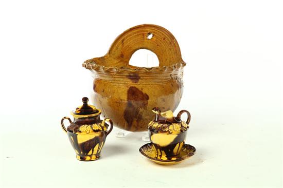 Appraisal: SLIP DECORATED WALL POCKET AND CHILD'S TEA SET American or