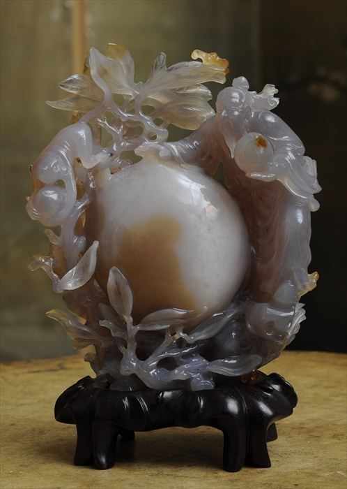 Appraisal: CHINESE CARVED AGATE FIGURE GROUP WITH KIWI FRUIT IMMORTAL AND