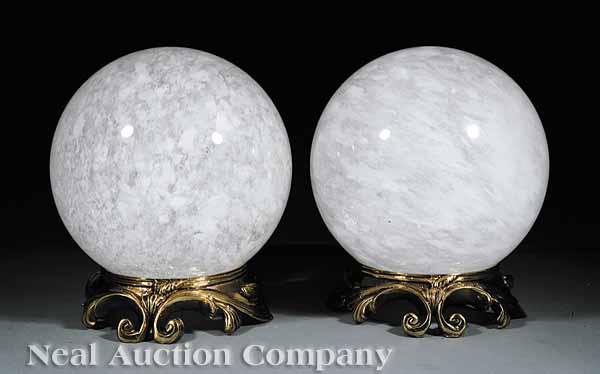 Appraisal: A Pair of Large Rock Crystal Spheres on molded gold-painted