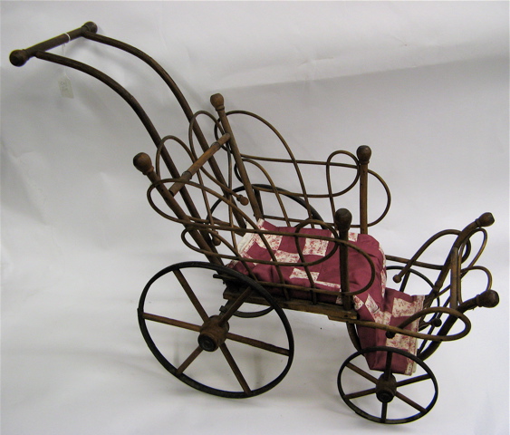 Appraisal: AN AMERICAN VICTORIAN DOLL BUGGY bent wood with metal covered