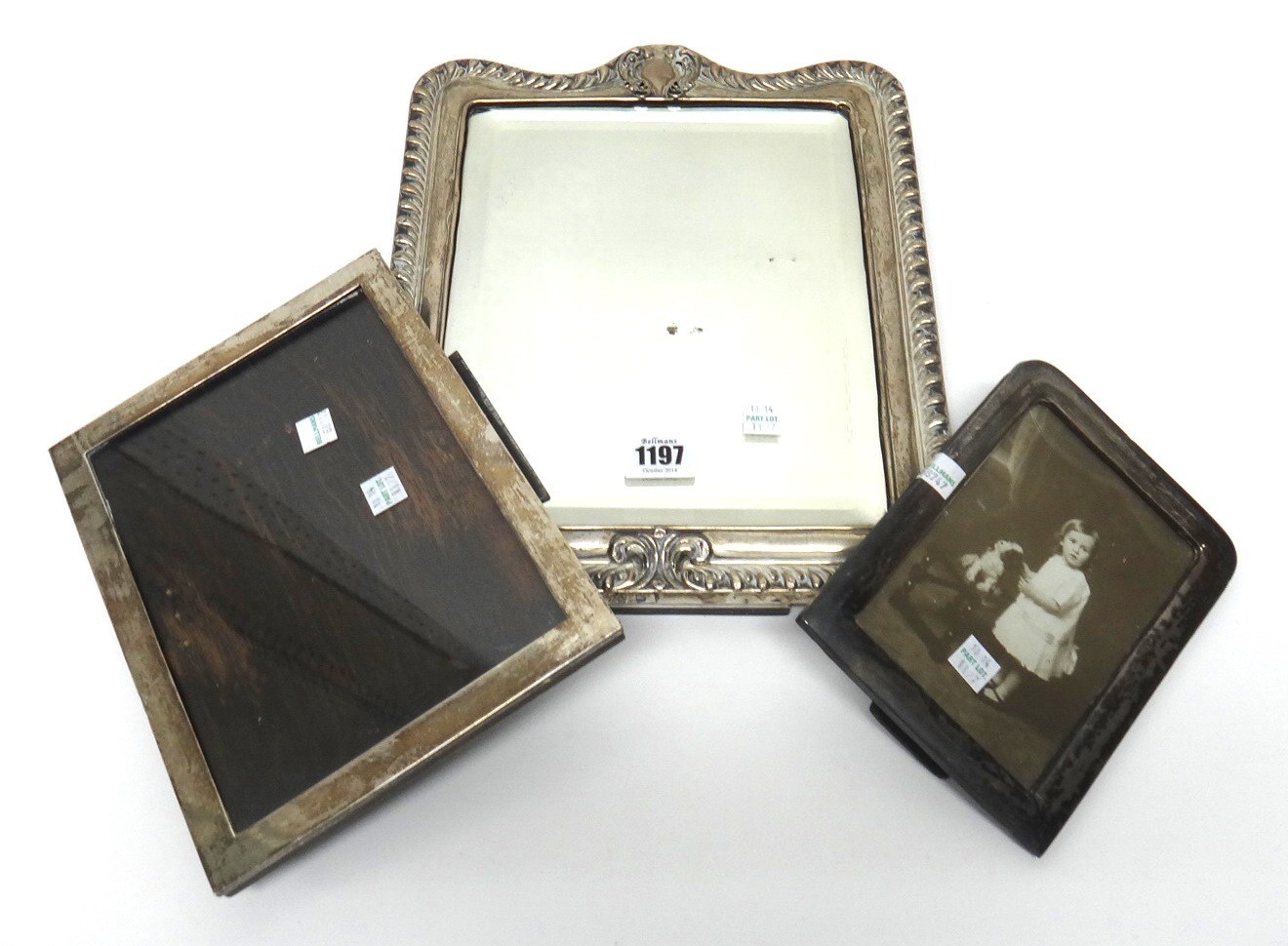 Appraisal: A silver mounted shaped rectangular mirror with an embossed border