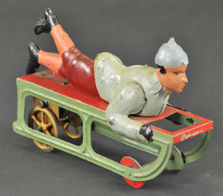 Appraisal: DAYTON BOY ON SLED Pressed steel friction driven colorful example