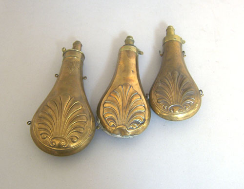 Appraisal: Three copper powder flasks late th c with shell design