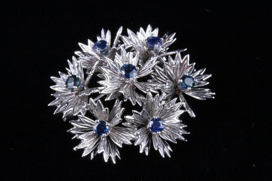 Appraisal: K WHITE GOLD AND SAPPHIRE LEAF CLUSTER PIN Domed cluster