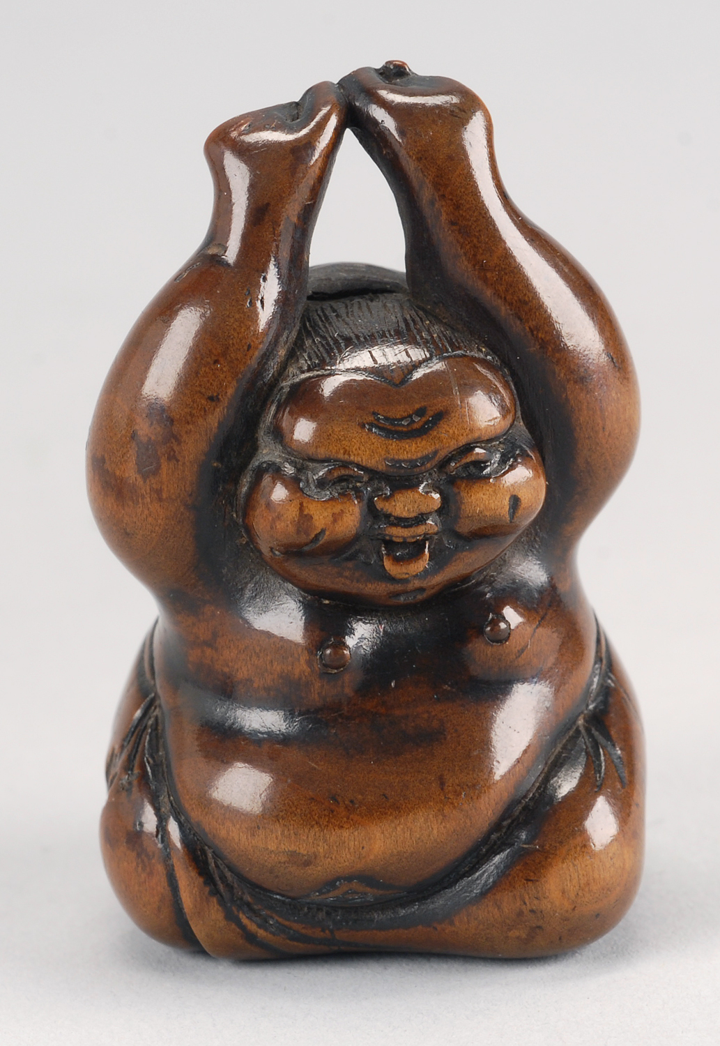 Appraisal: WOOD NETSUKE th CenturyDepicting Okame waking from a nap Signed