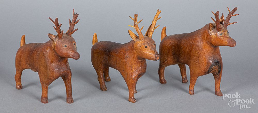 Appraisal: Three carved deer early th c Three carved deer early