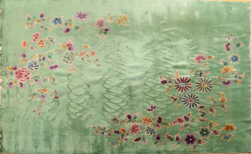 Appraisal: CHINESE WOOLWORK GREEN-GROUND CARPET Worked with flowering branches ft in