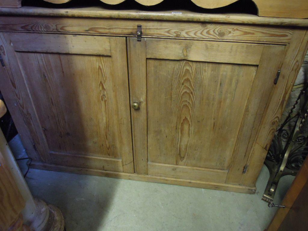 Appraisal: A Victorian stripped pine side cupboard enclosed by a pair