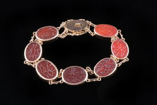 Appraisal: K YELLOW GOLD AND CARVED CARNELIAN FLEXIBLE LINK BRACELET Seven